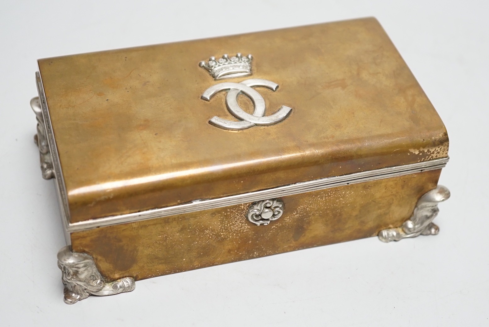 An unusual late Victorian silver mounted brass rectangular cigarette box, with applied monogram, Alfred Fuller, London, 1885, 16.4cm.